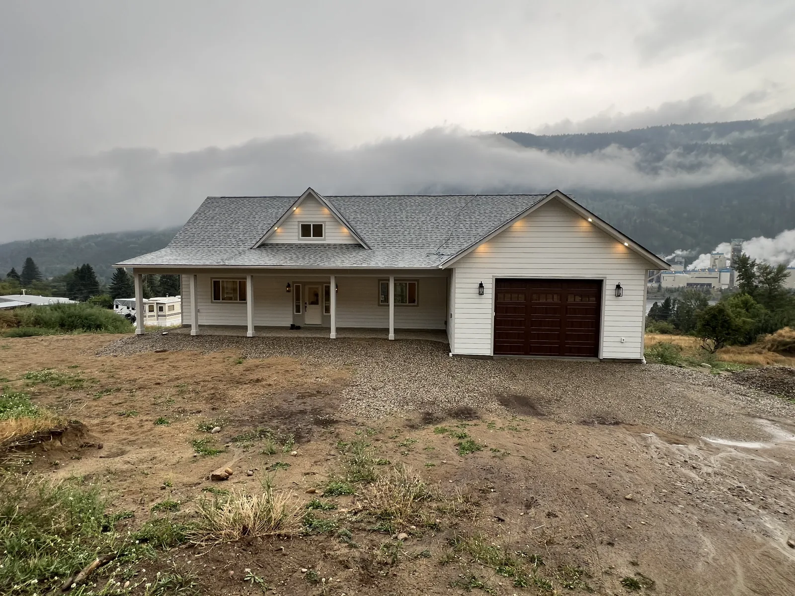 Residential exterior with a covered front porch and attached garage